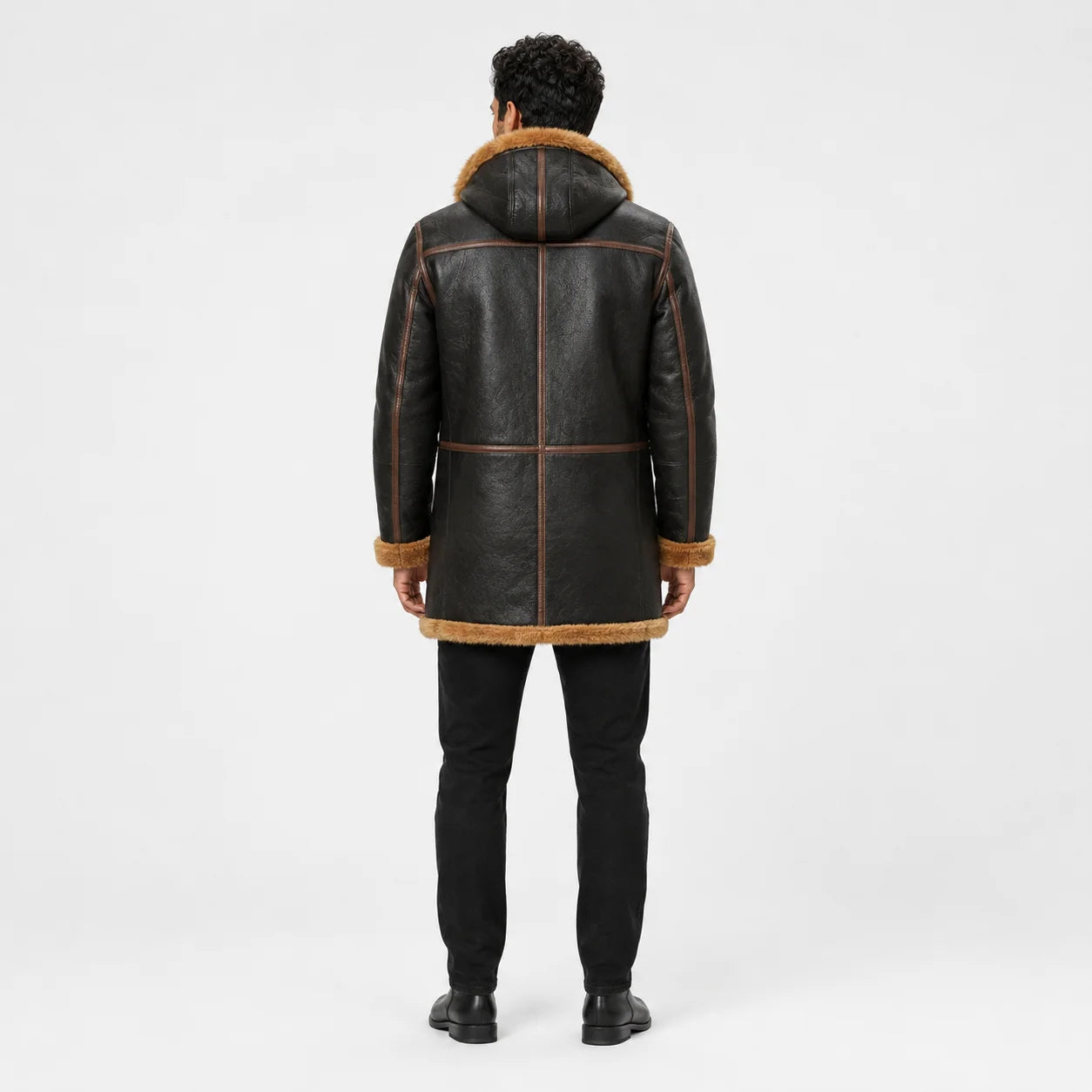 Back view of men’s B7 leather parka showing brown leather panels, hood construction and longer shearling-trimmed hem