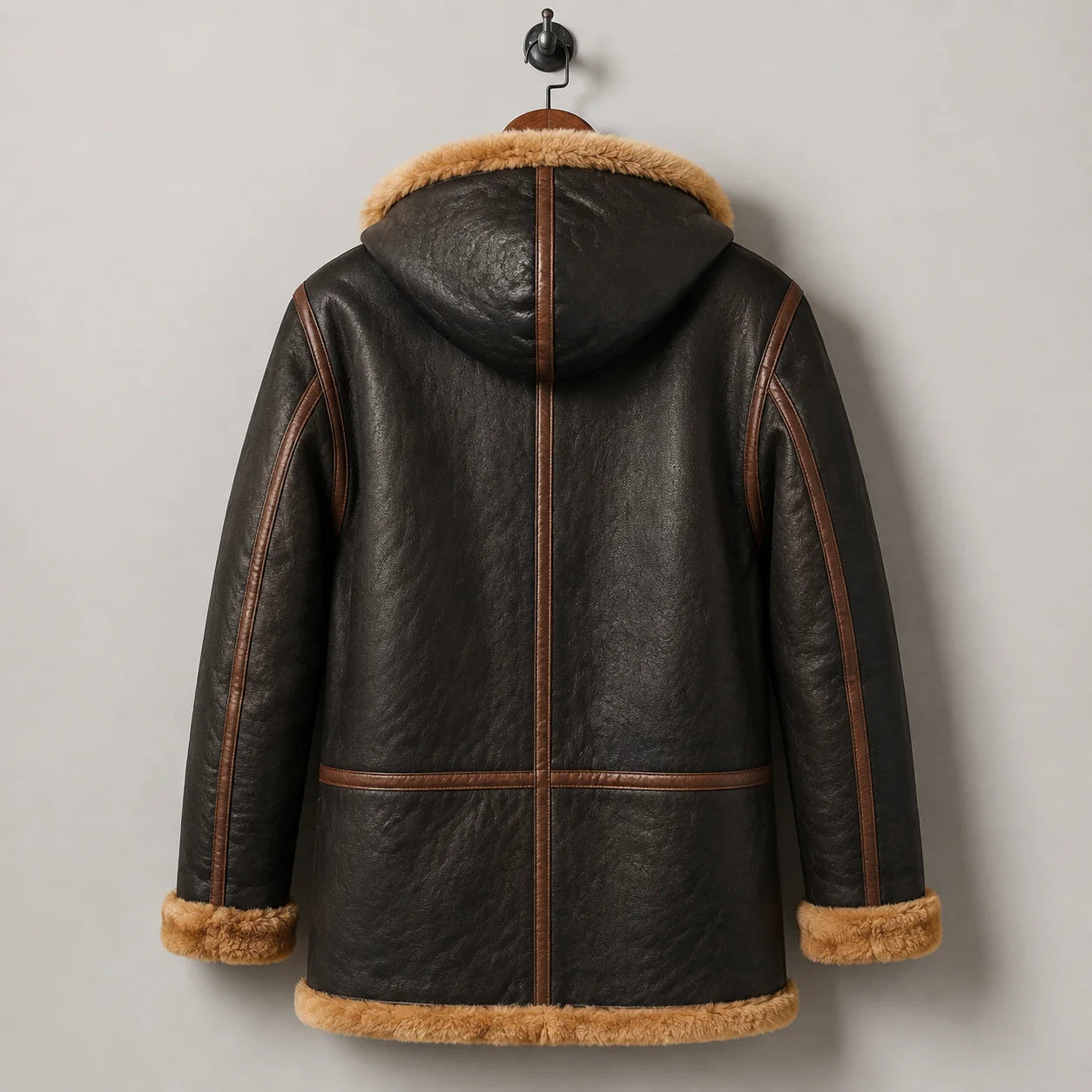 Rear hanging view of brown B7 leather flying parka showing hood, contrast seam piping and clean back panel construction