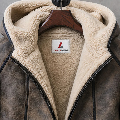 Close-up of cream shearling interior, lined hood, dark zipper, distressed brown leather and Leathvora neck label