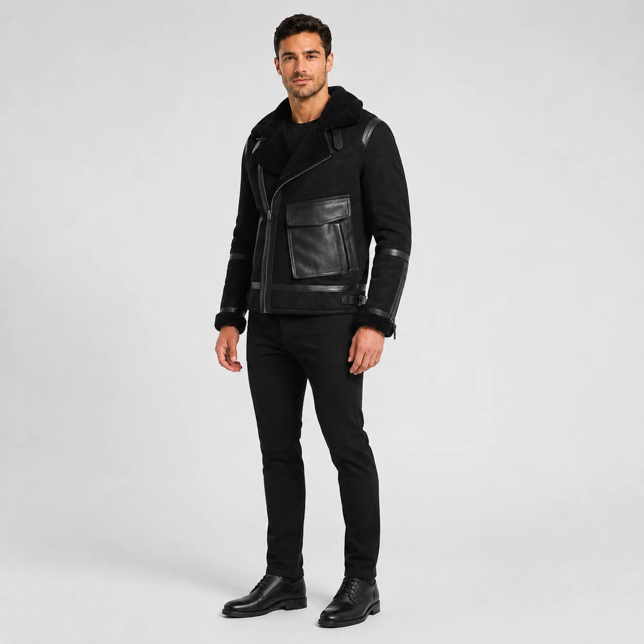Three-quarter studio view of black aviator biker jacket with asymmetric zip and large utility flap pocket