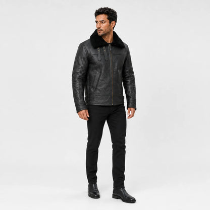 Three-quarter studio view of men’s black flight jacket highlighting plush collar, throat straps and structured fit