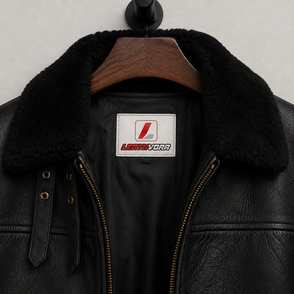 Close-up of plush black aviator collar, throat straps, zip teeth, textured outer finish and Leathvora branding