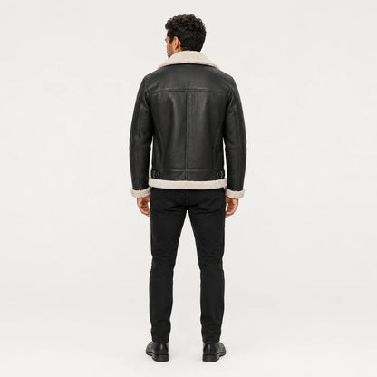 Rear model view of black aviator jacket showing white collar and hem trim, panelled back and waist buckle details