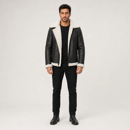 Straight-on model styling of black aviator bomber jacket with white contrast collar, cuffs and front trim