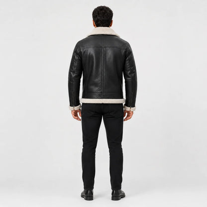 Rear model view of dark aviator leather jacket showing cream collar, structured back panels and fur-trimmed hem