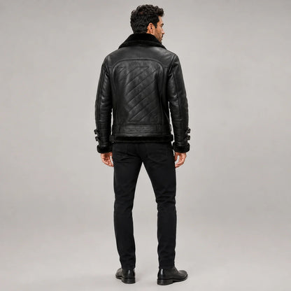 Rear model view of men’s black B3 jacket showing diagonal quilted back panel, waist belt and black fleece hem