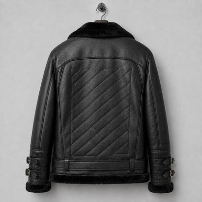Hanging rear view of black sheepskin flight jacket with large diagonal quilted centre panel and belted lower back