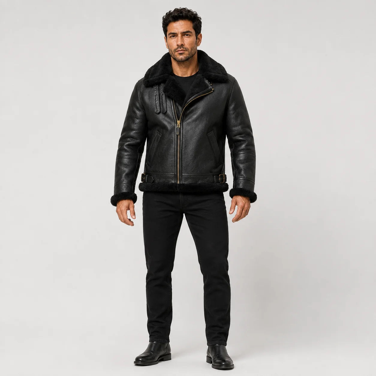 Front studio view of men’s black sheepskin aviator jacket with black shearling collar, cuffs and side buckle details