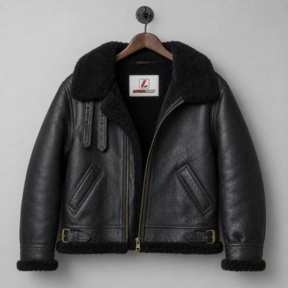 Front hanging view of black B3-style sheepskin jacket with shearling collar, angled pockets and eyelet strap details