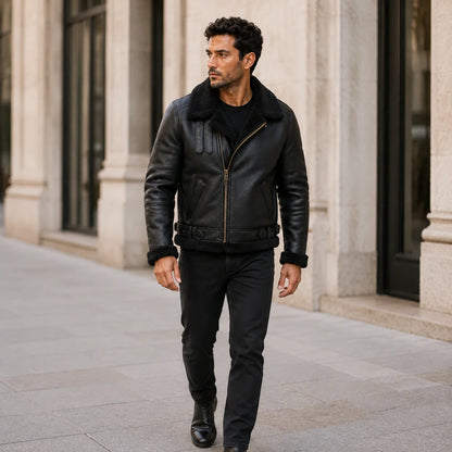 Outdoor lifestyle view of man wearing black shearling aviator leather jacket with black jeans and boots