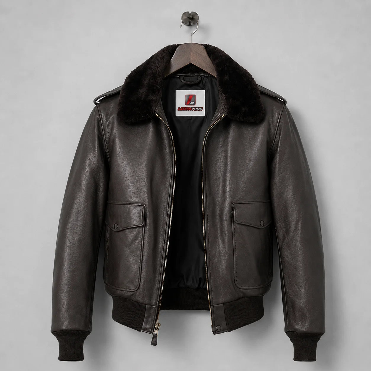 Front product view of brown leather flight jacket with map-print lining, two flap pockets and ribbed trims
