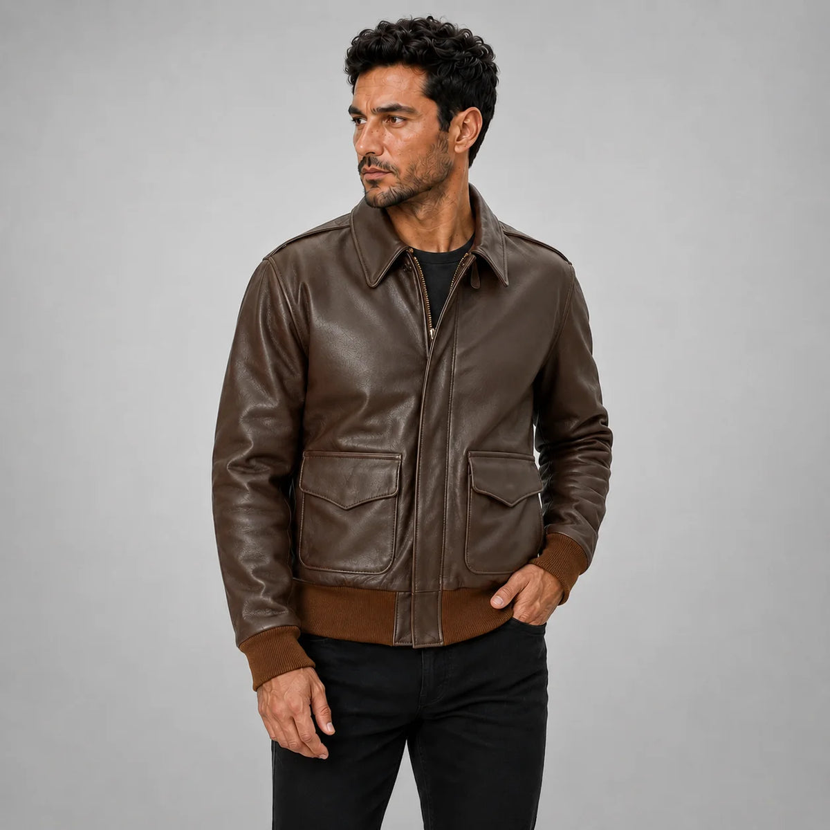 Studio three-quarter view of men’s brown leather aviator bomber with flap pockets, collar and rib-knit cuffs