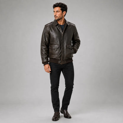 Three-quarter studio view of men’s brown leather bomber jacket with zip front and aviation-inspired details