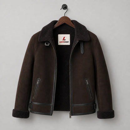 Hanging front view of dark brown flight jacket with black plush lining, collar buckles and two zip pockets