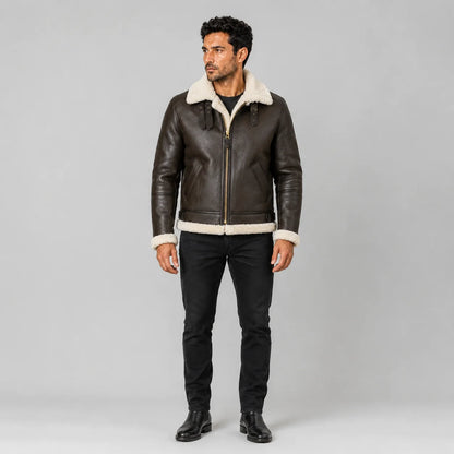 Front model view of men’s brown B3 leather bomber jacket with cream collar, zip front, angled pockets and waist buckles.