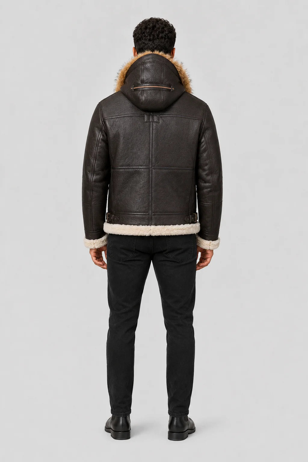 Closer rear view highlighting the structured hood, brown leather back panels, side waist buckles and cream trim.