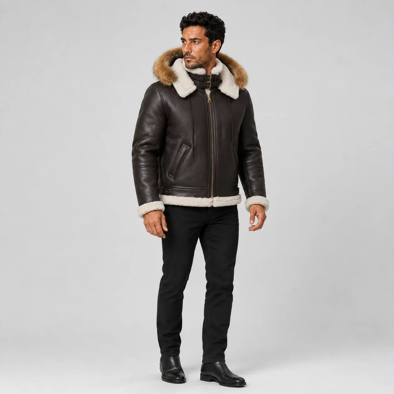 Three-quarter model view of dark brown shearling bomber jacket with fur-trim hood, zip closure and side pockets.