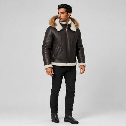 Three-quarter model view of dark brown shearling bomber jacket with fur-trim hood, zip closure and side pockets.