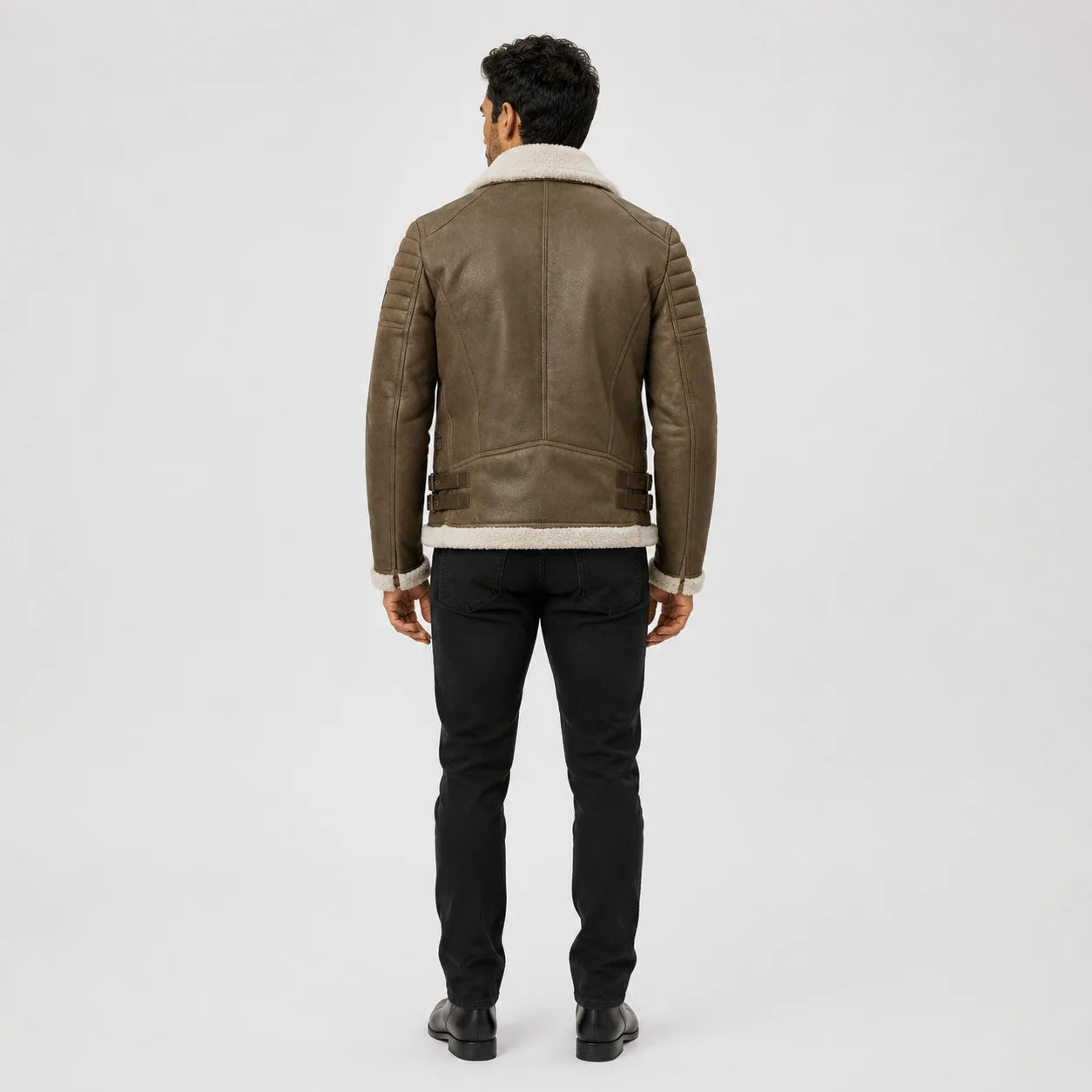 Rear model view of light sand brown shearling leather biker jacket with panelled back, side buckles and cream collar.