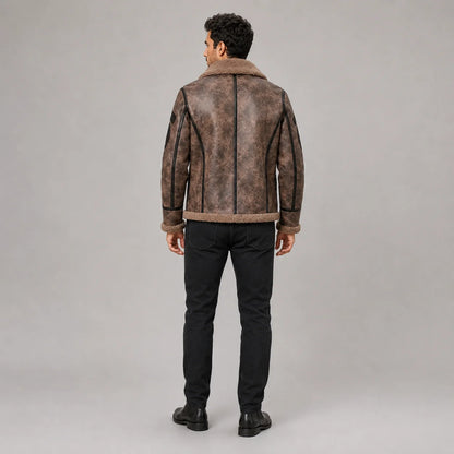 Rear view of men’s brown flight jacket showing plush collar, black centre trim and curved contrast back piping