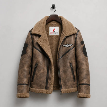Hanging front view of brown sheepskin aviator jacket with plush lining, aviation patches and two zipped pockets