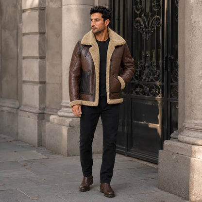 Brown B3 aviator jacket styled outdoors with black jeans and boots, showing shearling collar, zip pockets and straps