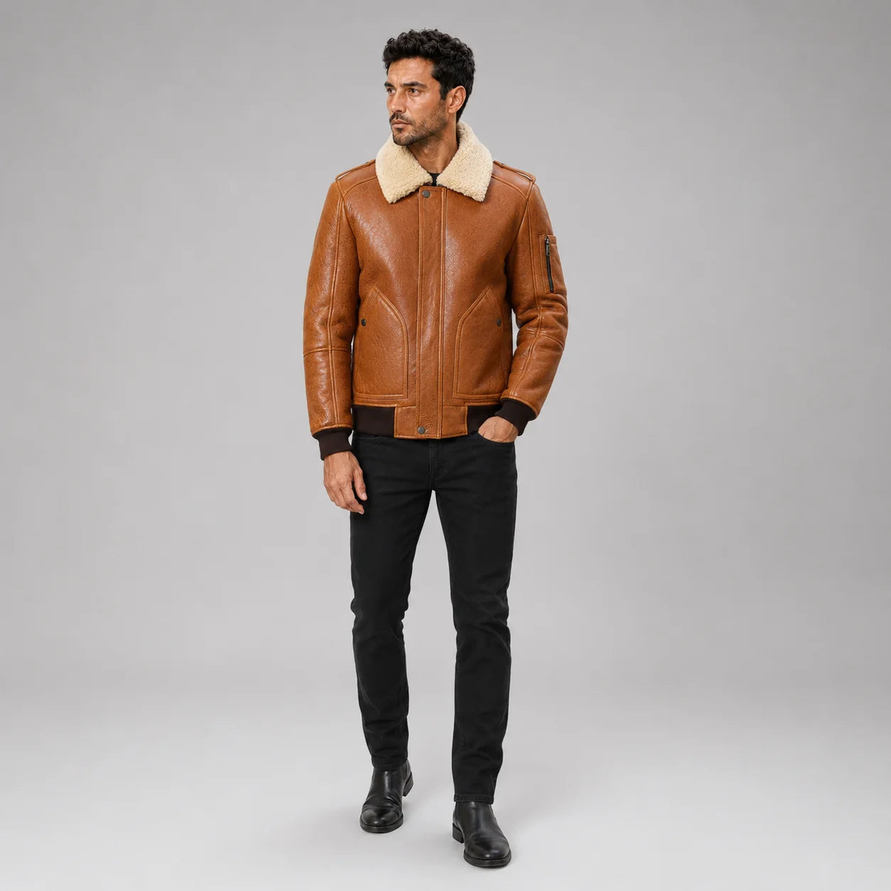 Front studio view of men’s camel brown B3 bomber jacket with cream collar, large pockets and dark ribbed trims