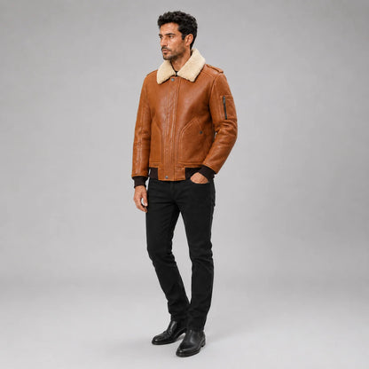 Three-quarter view of men’s brown aviator bomber with cream collar, sleeve zip pocket and black jeans