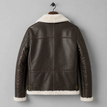 Hanging back view of men’s brown B3 jacket with leather panel seams, cream collar, cuffs and shearling hem.