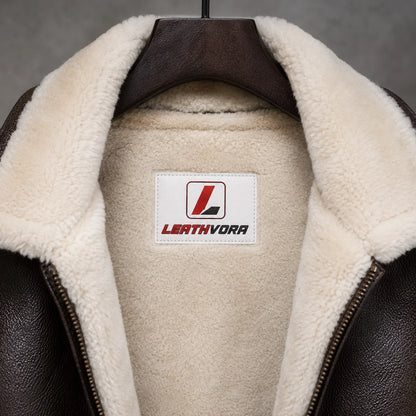 Close-up of cream shearling collar and lining inside brown B3 leather bomber jacket with Leathvora neck label.