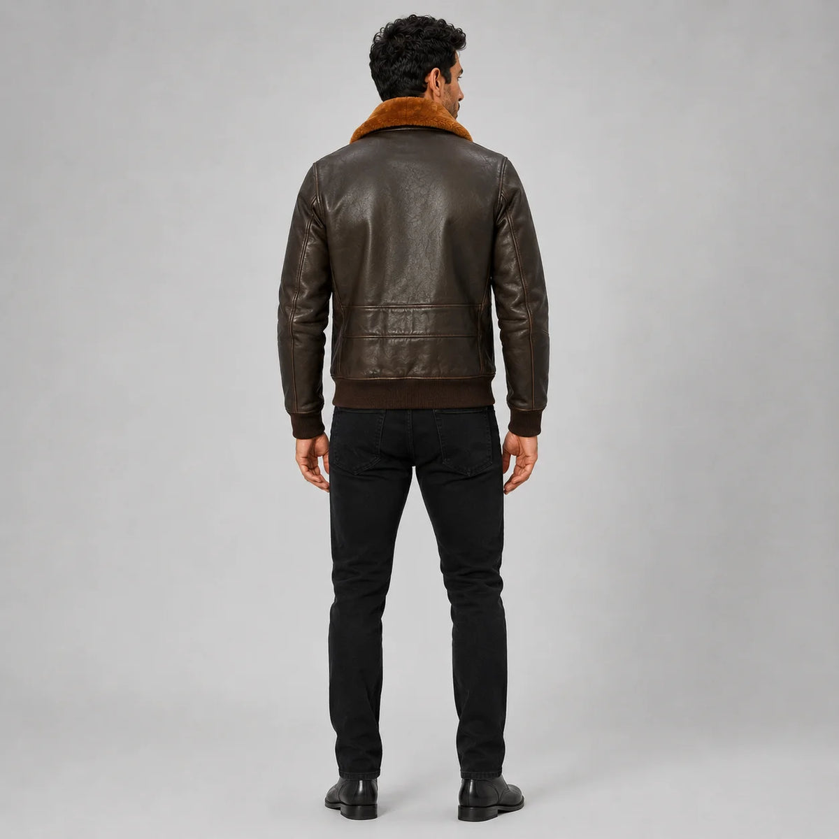 Rear model view of brown leather aviator jacket showing contrast collar, back panel and ribbed waistband
