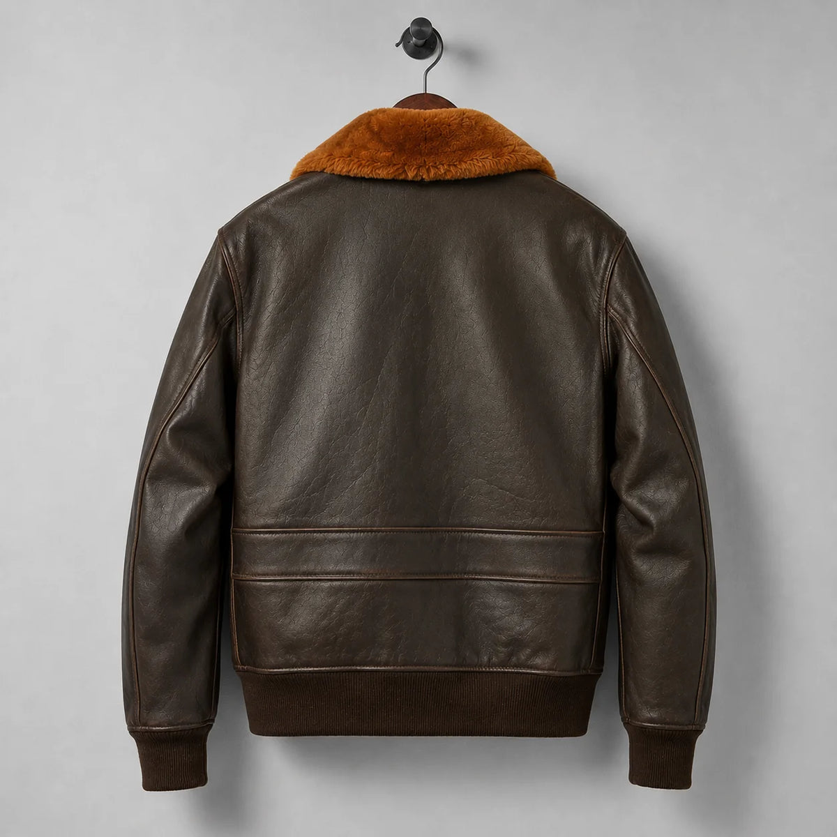 Rear product view of brown leather bomber jacket with rust collar, lower back panel and dark rib-knit waistband