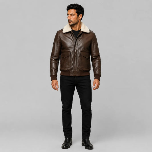 Full-length model wearing dark brown lambskin pilot bomber jacket with cream shearling collar and flap pockets.
