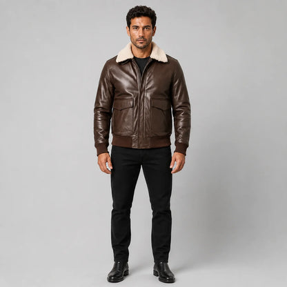 Straight front view of men’s brown leather bomber jacket showing zip closure, shearling collar and ribbed hem.