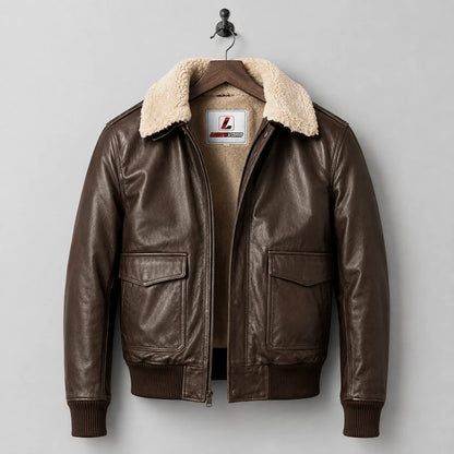 Hanging front view of brown pilot leather jacket showing shearling lining, front zip, flap pockets and ribbed cuffs.