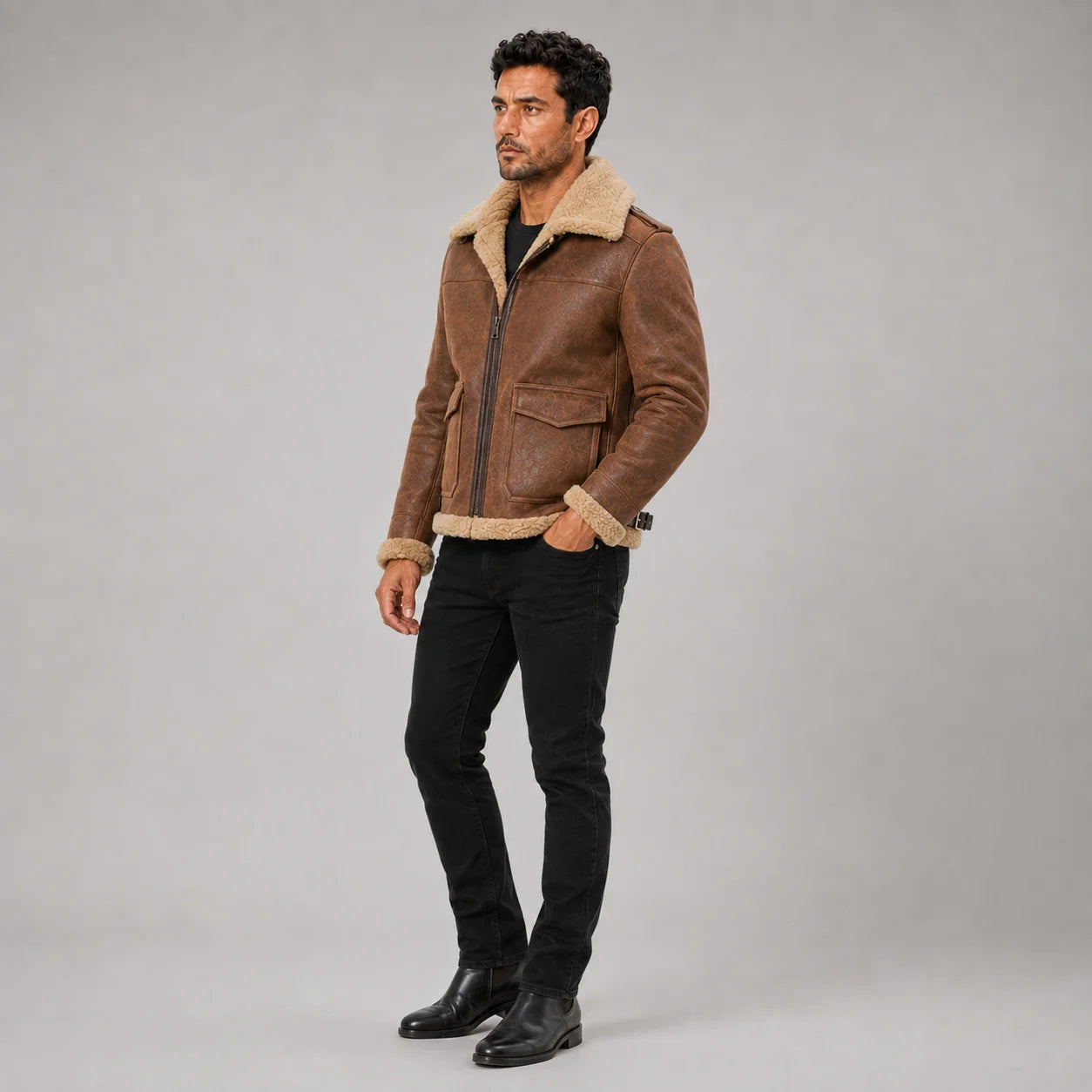 Three-quarter studio view of the men’s brown aviator jacket highlighting its flap pockets, zip front and short silhouette.