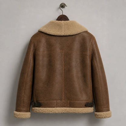 Hanging rear view of the brown jacket showing a structured yoke, centre back seam, side buckles and cream trim.