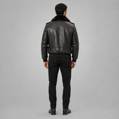 Full-length rear view of men’s brown leather bomber jacket showing fur collar, back panel seams and ribbed waist