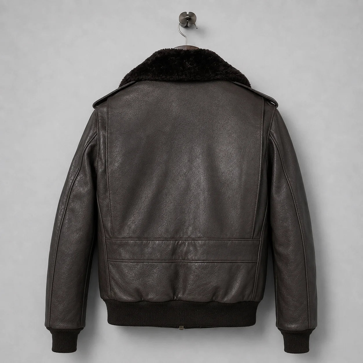 Back view of men’s dark brown leather flight jacket with plush collar, ribbed waistband and panelled bomber construction