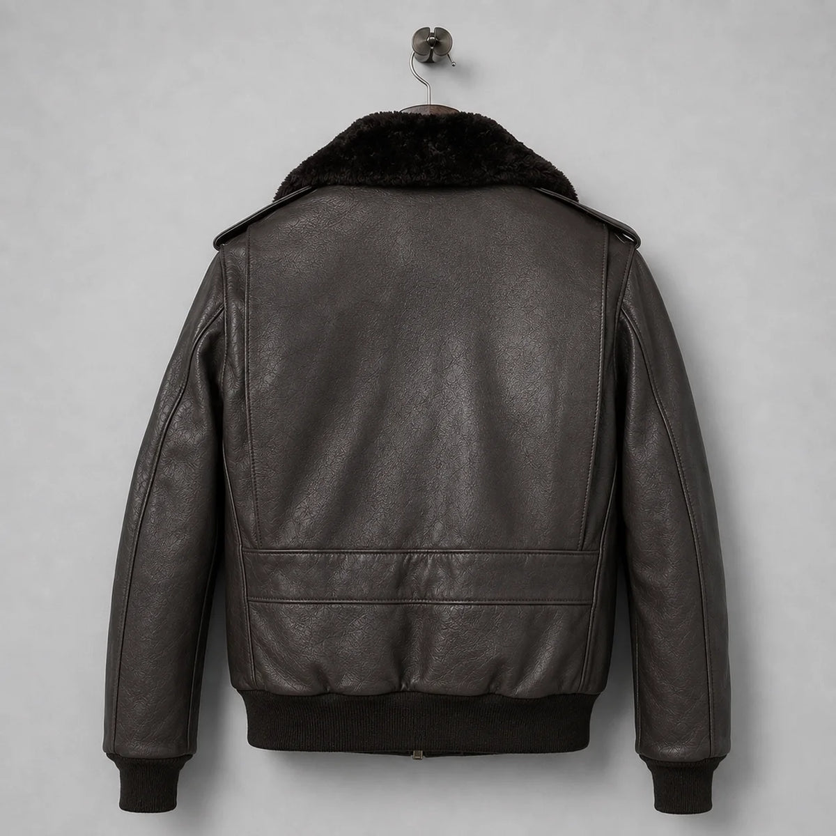 Back view of men’s dark brown leather flight jacket with plush collar, ribbed waistband and panelled bomber construction