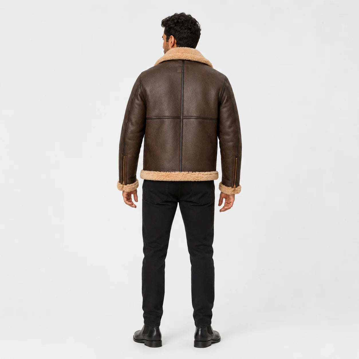 Rear model view of brown RAF B3 sheepskin jacket showing tan collar and hem trim with central and horizontal back seams.