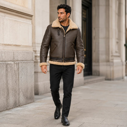 Outdoor lifestyle view of brown B3 sheepskin aviator jacket styled with black jeans and black leather boots.
