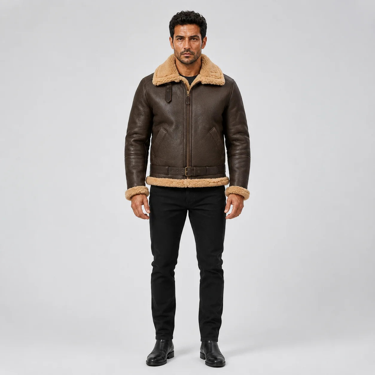 Straight front model view of men’s brown RAF B3 sheepskin bomber with tan collar, cuffs, hem, pockets and waist belt.