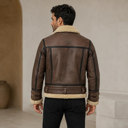 Rear model view of brown B3 aviator jacket with cream collar and hem, contrast piping, belted waist and buckle cuffs