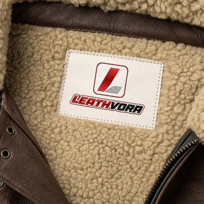 Close-up of cream fleece lining with Leathvora neck patch, brown leather collar straps and front zipper detail