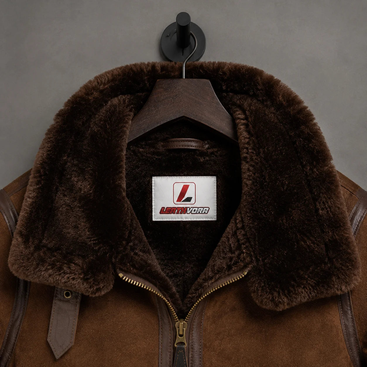Close-up of chocolate shearling collar and lining with Leathvora label, suede texture and front zipper detail