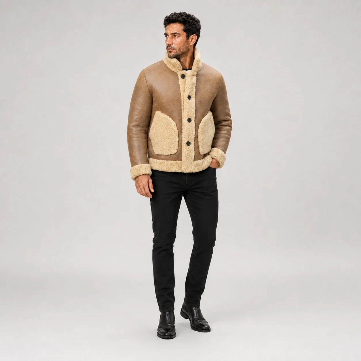 Men’s camel brown B3 jacket styled outdoors with black jeans and boots, showing button front and cream pockets