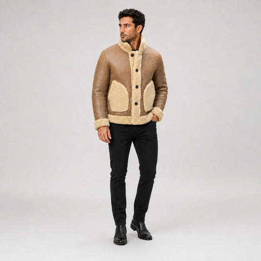 Men’s camel brown B3 jacket styled outdoors with black jeans and boots, showing button front and cream pockets