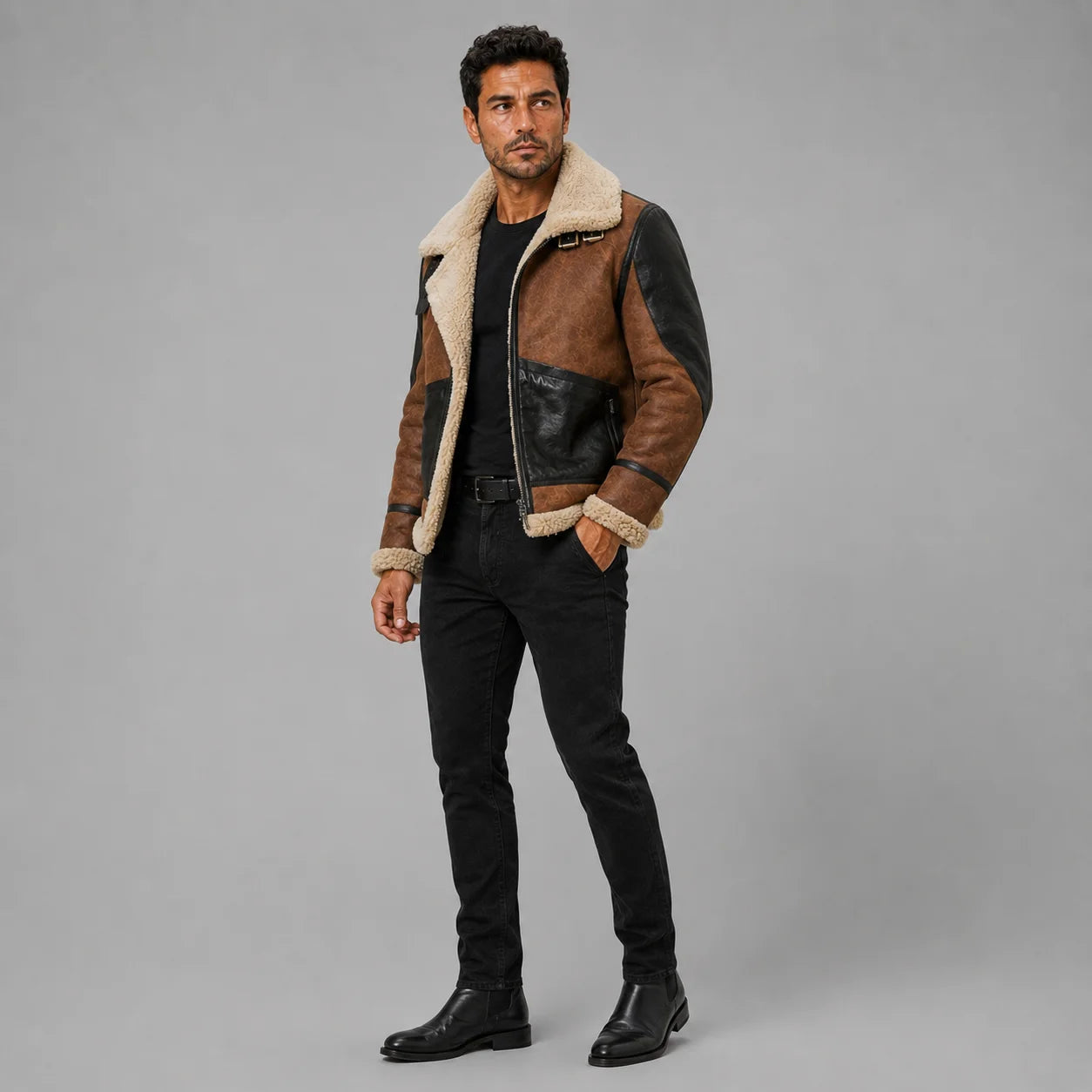 Three-quarter studio view of two-tone B3 suede bomber jacket with shearling collar, black pockets and zip front