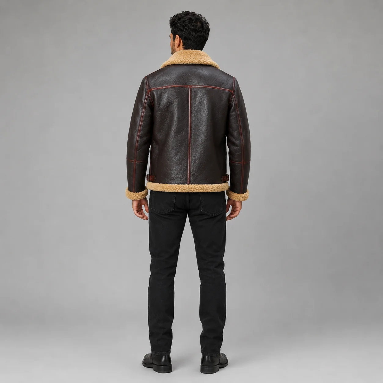 Rear model view showing dark brown flight jacket with tan collar, contrast back seams and side waist adjusters